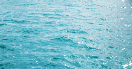 blue sea water with some ripples and small waves