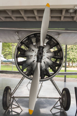 Frontal view of a vintage aircraft shows the engine and propeller.