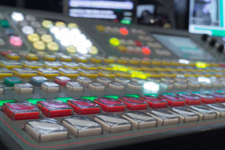 Wide shot of vision mixing panel in a television gallery.