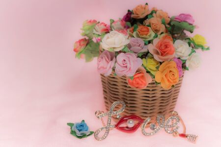 glass and wildflowers in basket on pink pattern background,soft focusの写真素材