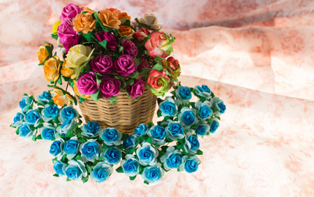 beautiful bouquet of bright wildflowers in basket on pink pattern backgroundの写真素材
