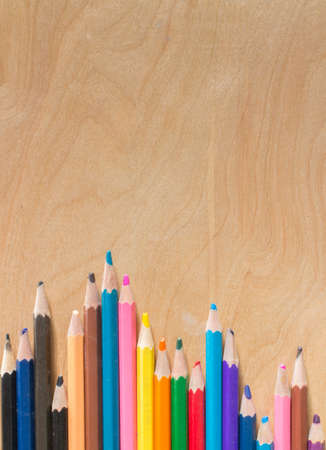 Colored pencils set/Many different colored pencils on wood backgroundの写真素材