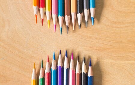 Colored pencils wave/Many different colored pencils on wood backgroundの写真素材