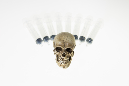 Human skull and Medical equipment on white backgroundの写真素材