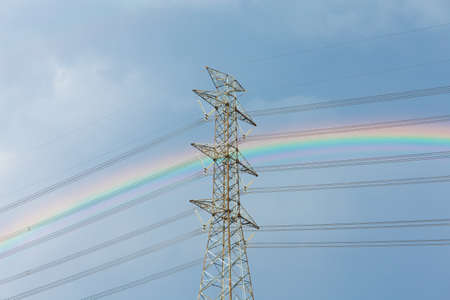 high voltage tower with rainbowの写真素材