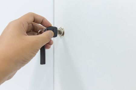 Hand open locker with keys, key in keyholeの写真素材
