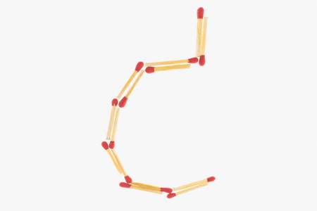 letter c  made of safety match isolated on white backgroundの写真素材