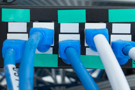 Network switch HUB and ethernet cables (LAN) in data center.