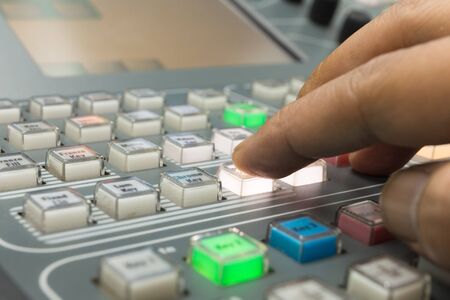 Hands of a cinematographer who worked on the vision mixer, switch the TV panel to the gallery.の写真素材