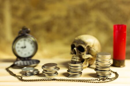 Staircase of money, Thai coins of one bath on wood and element antique clock,skull ,Shotgun shell background.Concept of financial planning and savings.の写真素材