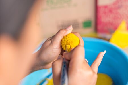 Woman's hand carved pumpkin flowers.の写真素材