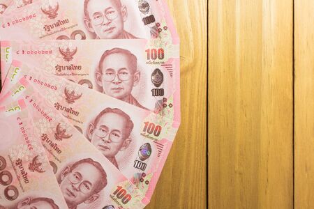Thai banknotes money on wood background.の写真素材