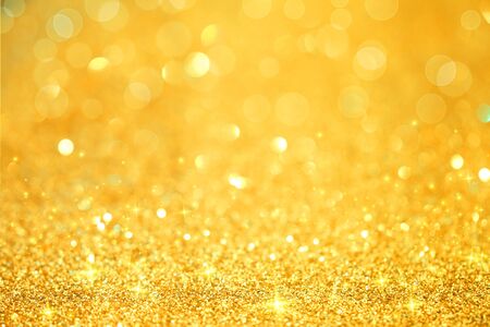 Luxury gold glitter with bokeh background, de-focused. concept for chrismas, holiday, happy new year, decoration.の写真素材