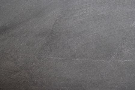 Texture of chalk rubbed out on blackboard or chalkboard background. School education, dark wall backdrop or learning concept.の写真素材