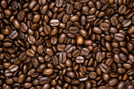 Top view of brown roasted coffee beans, can be use as background, copy space for text.の写真素材