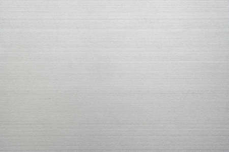 Silver metal texture of brushed stainless steel plate with the reflection of light.の写真素材