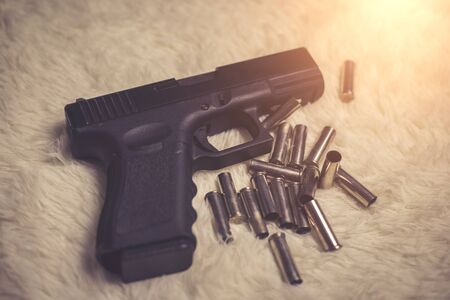 Gun with ammunition on white background.の写真素材