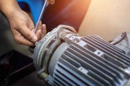 The mechanic has been working on disassembling the motor.の写真素材