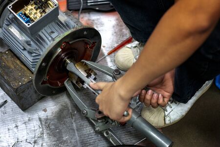 The mechanic has been working on disassembling the motor.の写真素材