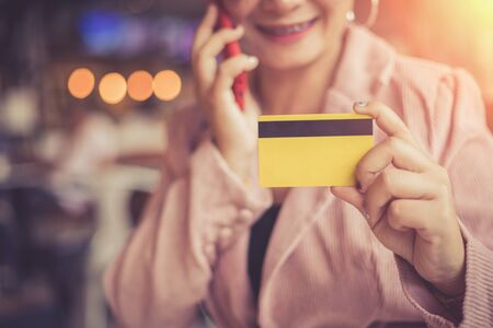 Business women are making financial transactions using a smartphone without using an ATM card with a smiling faceの写真素材