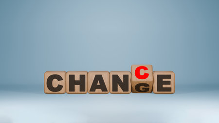 Wooden dice spelling 'CHANGE' with a red 'C' for 'CHANCE', representing the transformation of change...