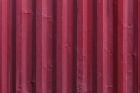 Red profiled metal wall of a cargo containerの写真素材