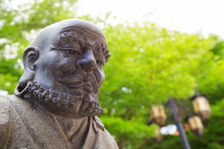 Monk statue in a garden templeの写真素材