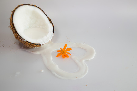 coconut milk and flower on white backgroundの写真素材