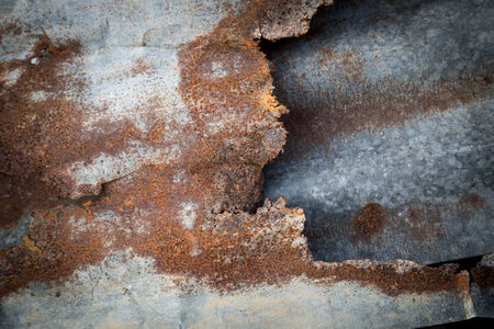 Tear of old tin and rust background 