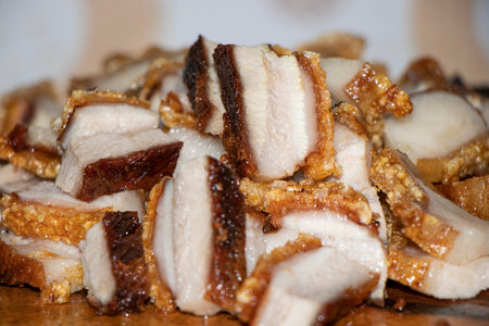 Close up Oriental Roast Crispy pork belly on wooden chopping boardの写真素材