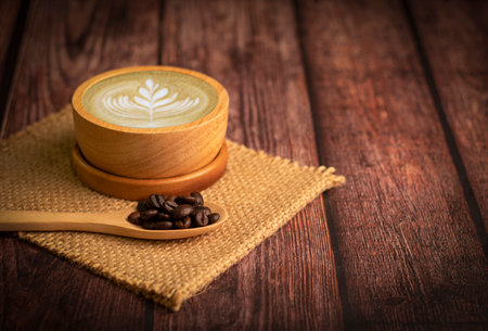 Hot coffee cup with organic coffee beans on the wooden table and the black background, Copy spaceの写真素材