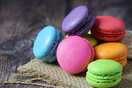 Colorful macaron cake or macaroon on wooden background, Small French cakes.の写真素材