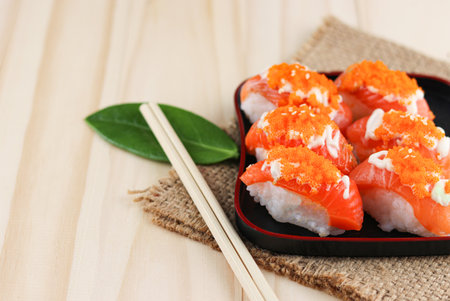 Salmon sushi on wooden background, Japanese style, Slices of raw salmon fillet, Copy space.の写真素材