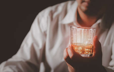A drink for the man. Cropped closeup of a man drinking whiskey at the bar.