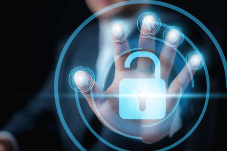 Businessman holding a Digital fingerprint identification for unlock. , Fingerprint scan provides security access with biometrics identification. Business Technology Safety Internet Concept.の写真素材