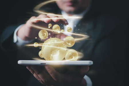 Businessman with hands offers bitcoin concept design, Making money with bitcoin - Business man creating bitcoins with his hand.の写真素材