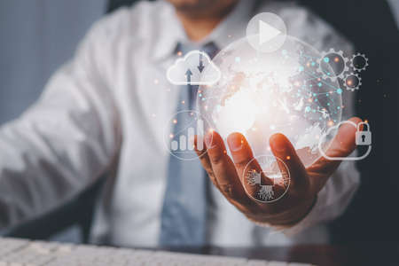Man holding virtual globe with  network connecting icons on hand. Innovation technology develop...