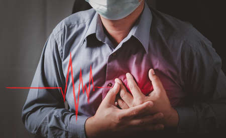 Men have chest pain caused by heart disease, heart attack, heart leakage, coronary heart disease.の写真素材