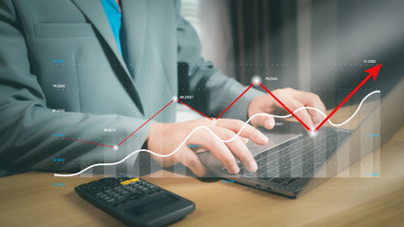 Financial growth and accounting analysis concept with businessman using calculator and virtual bar chart. Perfect for business success, revenue growth, finance report, and investment planning.の写真素材