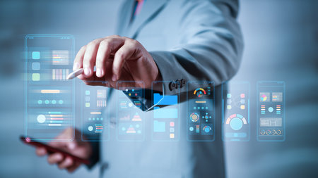 Businessman using digital interface with smartphone and stylus, analyzing data visualization, mobile...