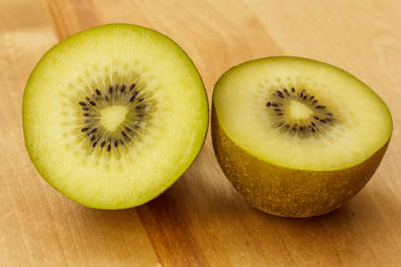 kiwi fruit on wooden cutting boardの写真素材