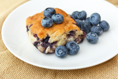 Blueberry scone on white plate and cloth.の写真素材