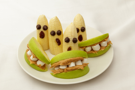 Healthy Halloween snacks apples and bananasの写真素材