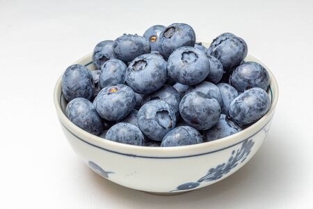 Bowl of blueberries on white background.の写真素材