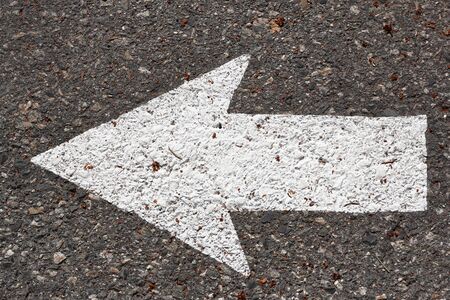 White arrow painted on path pavement.の写真素材