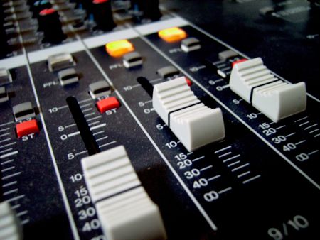 the faders and buttons of an audio mixer