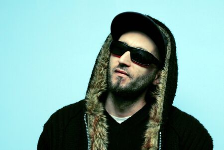 Young man portret with hip hop apearance on blue background