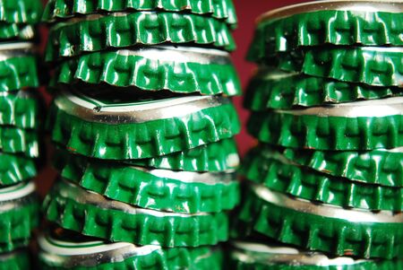 pile of green beer caps close up good for backgroundの写真素材