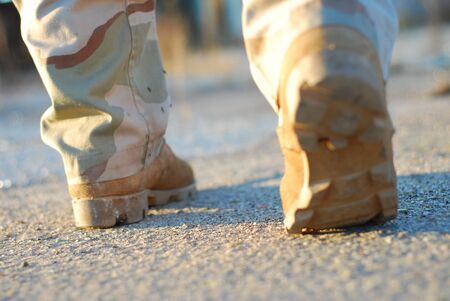 close up of soldier boots walking seen from behindの写真素材