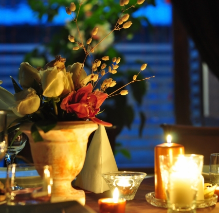 romantic dinner decoration with flowers and candlesの写真素材